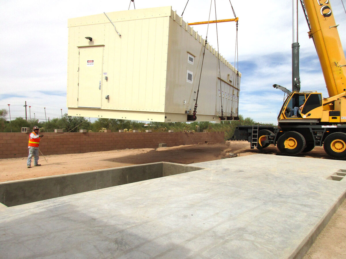 Enclosure being dropped into place by crane