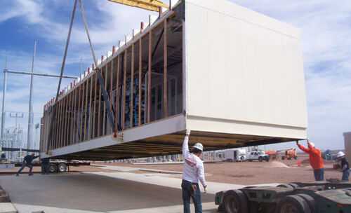 Delivery of a split enclosure section by crane.