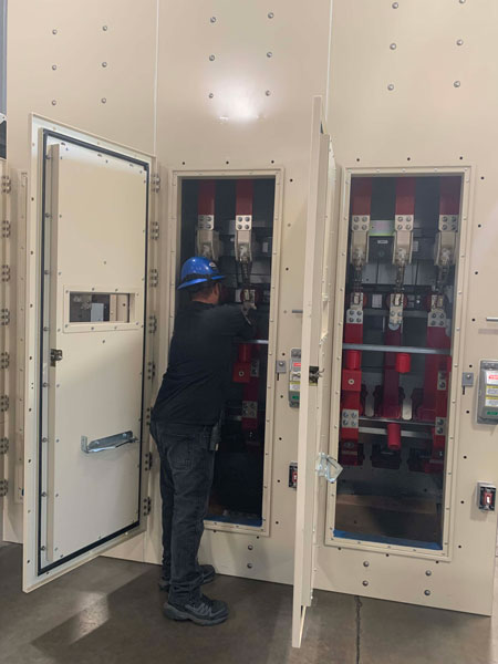 Crown employee working on an arc-resistant switchgear on the factory floor